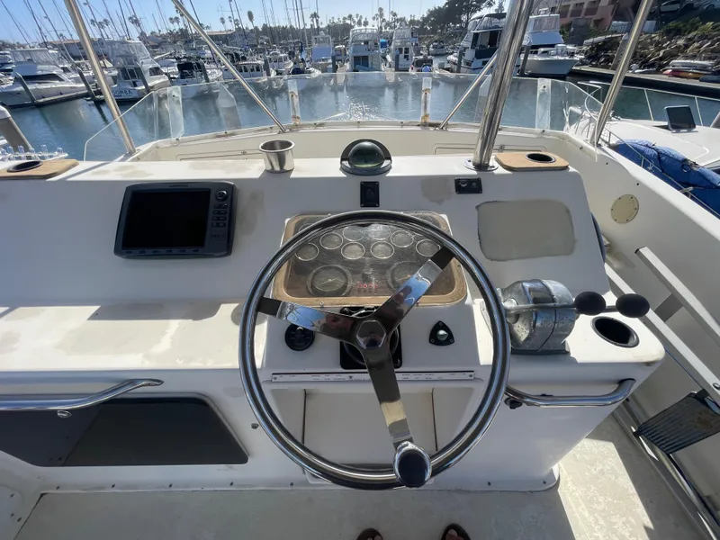 Slide: The Image of 1989 Ocean Yachts 35 Super Sport docked in a sunny marina. - 23
