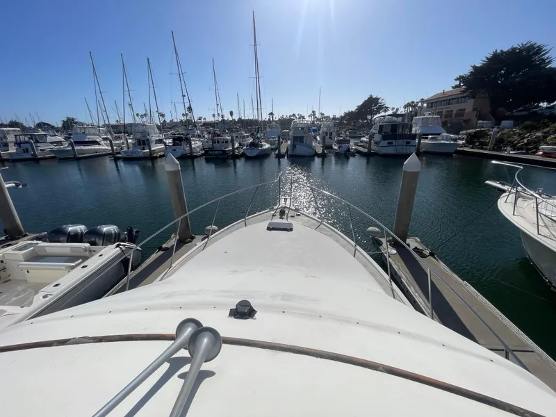 Slide: The Image of 1989 Ocean Yachts 35 Super Sport docked at marina, showcasing elegant design. - 24