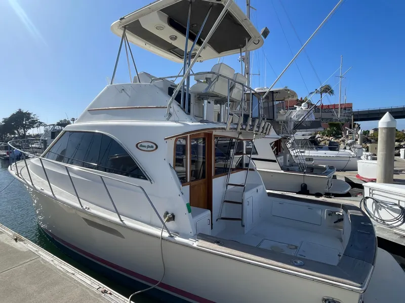 Slide: The Image of 1989 Ocean Yachts 35 Super Sport docked at marina under clear blue sky. - 3