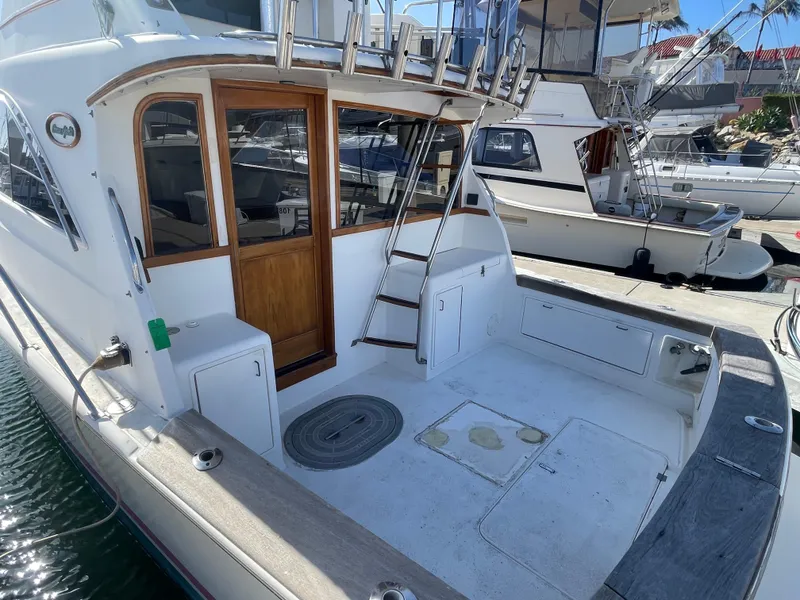 Slide: The Image of Interior of 1989 Ocean Yachts 35 Super Sport with cozy seating and wooden accents. - 5