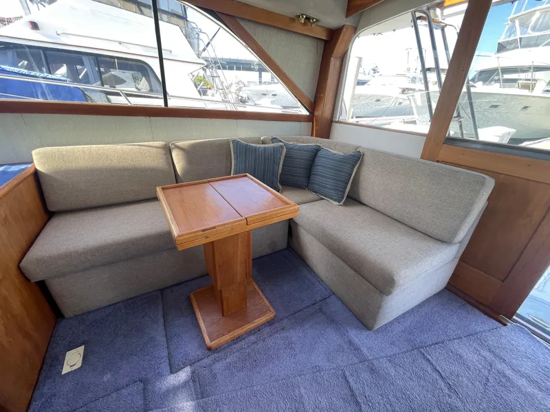 Slide: The Image of Interior of 1989 Ocean Yachts 35 Super Sport with cozy seating and wooden table. - 7