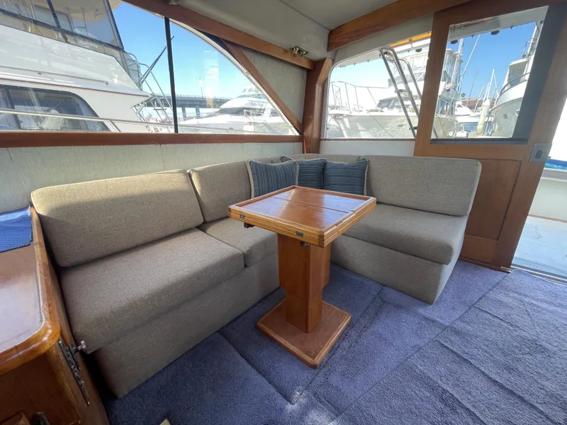 Slide: The Image of Interior of 1989 Ocean Yachts 35 Super Sport with plush seating and wooden cabinetry. - 8
