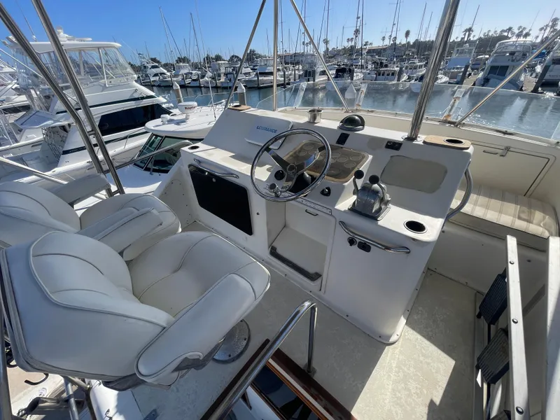 Slide: The Image of Cockpit view of 1989 Ocean Yachts 35 Super Sport, featuring steering wheel and control panel. - 22