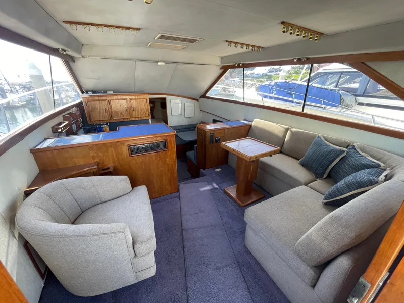 Slide: The Image of Cozy interior of 1989 Ocean Yachts 35 Super Sport with plush seating and wooden table. - 6