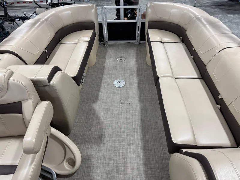 Slide: The Image of 2018 Sun Tracker Party Barge 24 DLX XP3 interior with beige seating and spacious layout. - 11