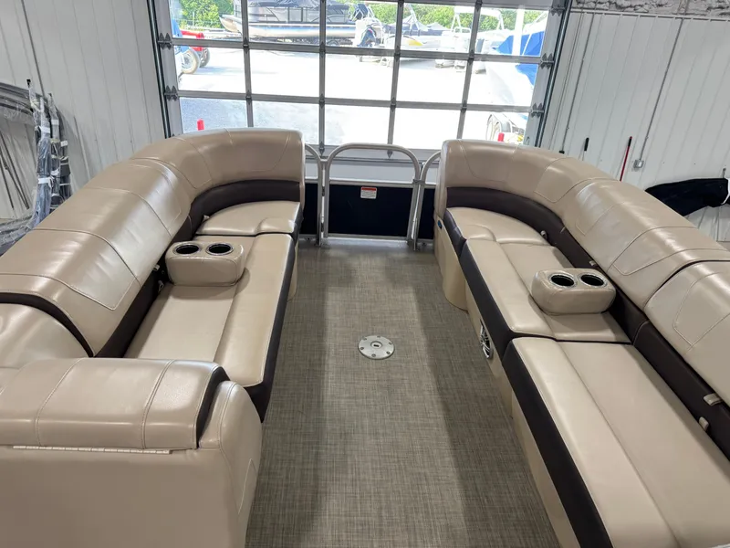 Slide: The Image of 2018 Sun Tracker Party Barge 24 DLX XP3 interior with beige seating and cup holders. - 12