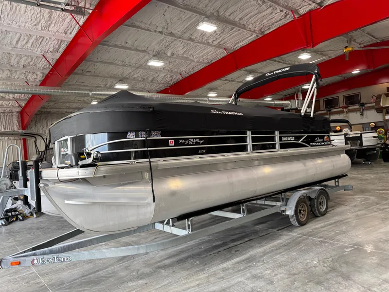 Slide: The Image of 2018 Sun Tracker Party Barge 24 DLX XP3 pontoon boat in a showroom on a trailer. - 6