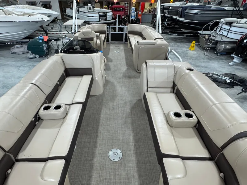 Slide: The Image of 2018 Sun Tracker Party Barge 24 DLX XP3 interior with beige seating and cup holders. - 7