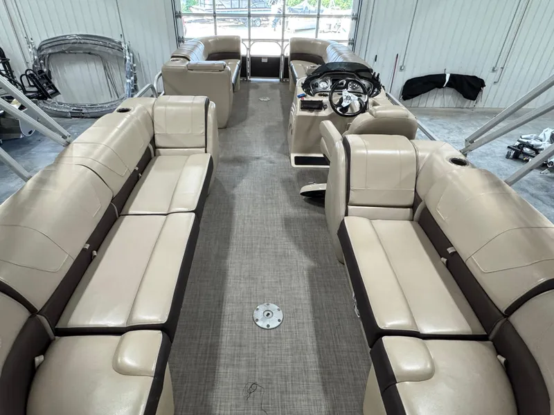Slide: The Image of 2018 Sun Tracker Party Barge 24 DLX XP3 interior with beige seating and steering console. - 8