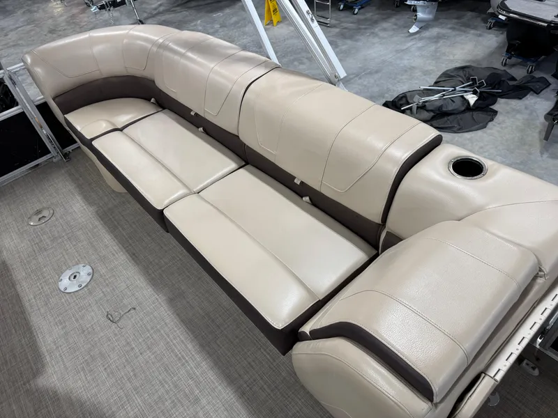 Slide: The Image of 2018 Sun Tracker Party Barge 24 DLX XP3 seating area with beige upholstery and cup holder. - 9
