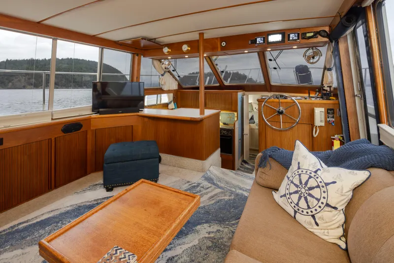 Slide: The Image of Interior of 1990 Tollycraft 44 Cockpit Motor Yacht with cozy seating and helm. - 13