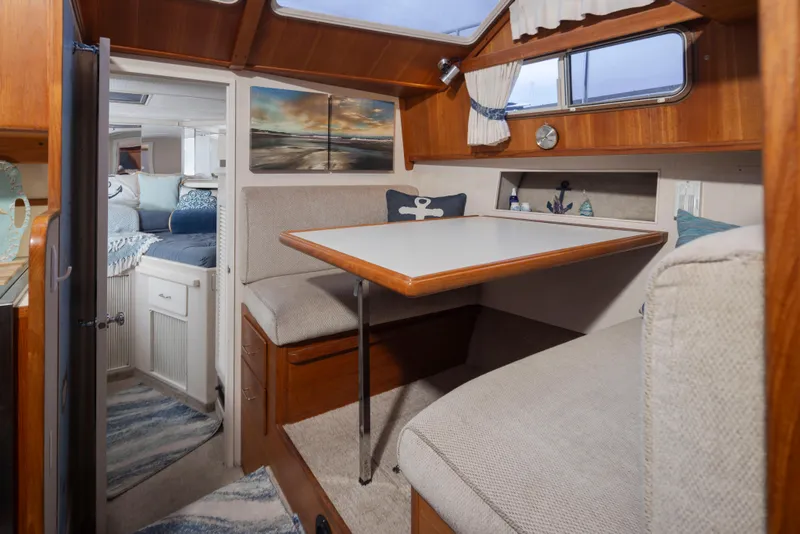 Slide: The Image of Interior of 1990 Tollycraft 44 Cockpit Motor Yacht with cozy dining area and nautical decor. - 22