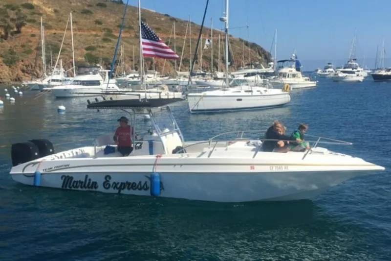 Slide: The Image of 2004 Fountain 31 Tournament Edition boat, "Marlin Express," in a marina with American flag. - 6