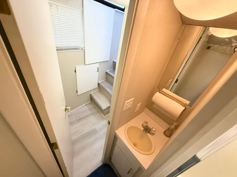 Slide: The Image of Compact bathroom in 1995 Skipperliner 52 Inter-Coastal Motor Yacht, featuring sink and mirror. - 20