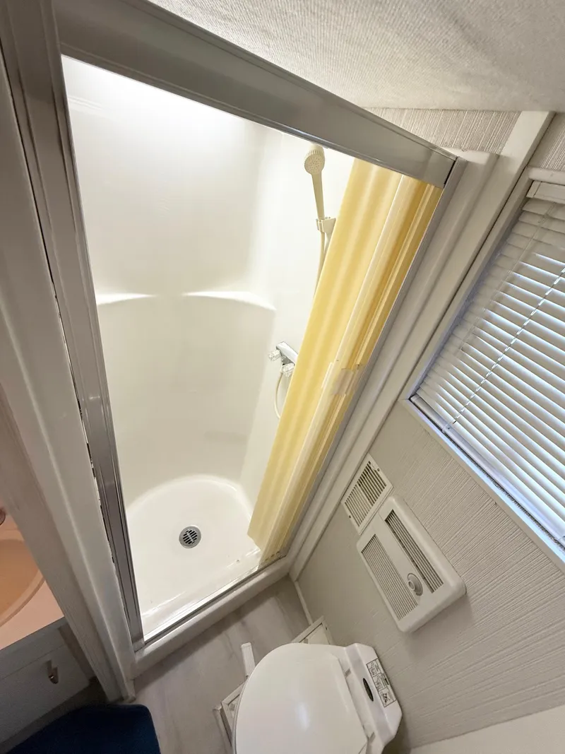 Slide: The Image of Bathroom interior of 1995 Skipperliner 52 Inter-Coastal Motor Yacht HB, featuring shower and toilet. - 23