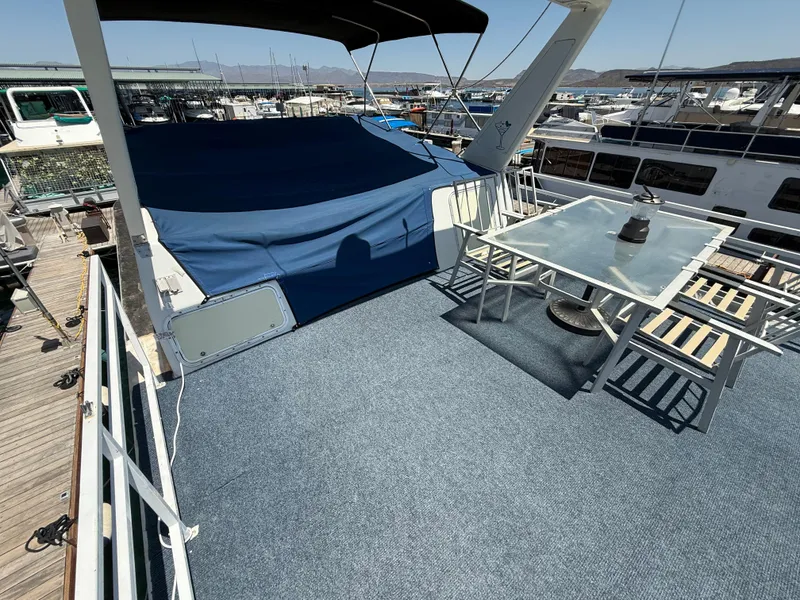 Slide: The Image of 1995 Skipperliner 52 Inter-Coastal Motor Yacht HB with outdoor seating and covered deck area. - 28