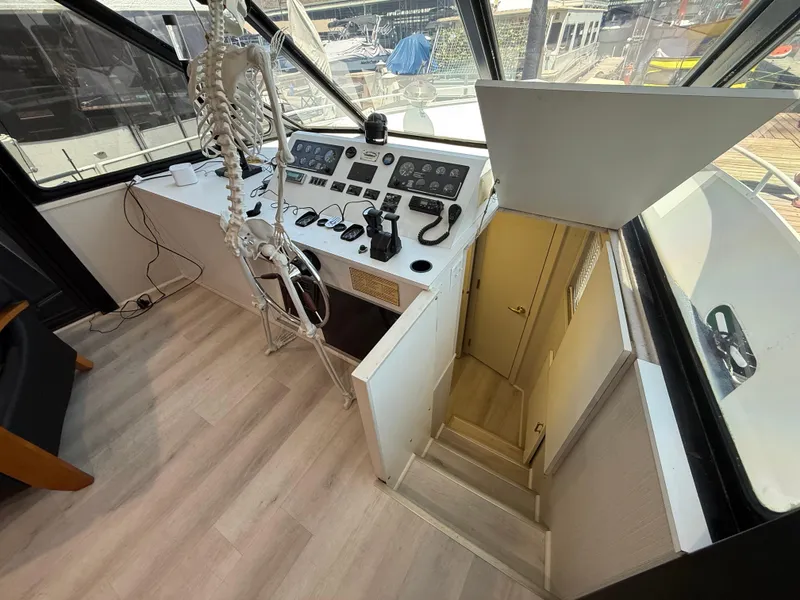 Slide: The Image of 1995 Skipperliner 52 Inter-Coastal Motor Yacht helm with skeleton model, interior view. - 7