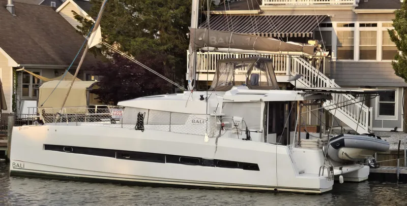 The Image of 2018 Bali 4.1 Catamaran docked near waterfront homes. - 0