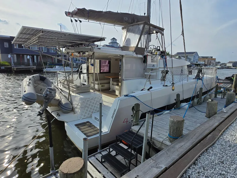 Slide: The Image of 2018 Bali 4.1 Catamaran docked, featuring solar panels and an inflatable dinghy. - 1