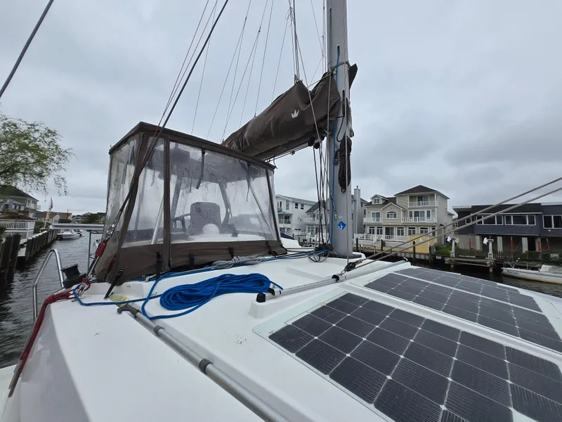 Slide: The Image of 2018 Bali 4.1 Catamaran docked, featuring solar panels and a covered cockpit. - 11