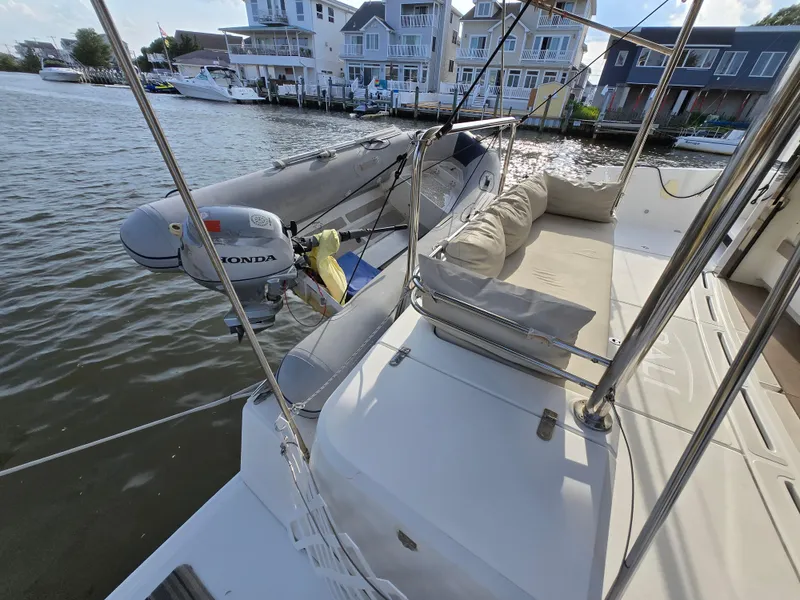 Slide: The Image of 2018 Bali 4.1 Catamaran with dinghy and waterfront view. - 13