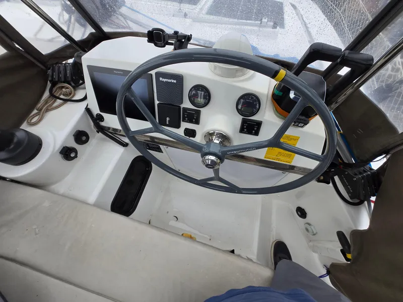 Slide: The Image of Steering wheel and controls of a 2018 Bali 4.1 Catamaran cockpit. - 29