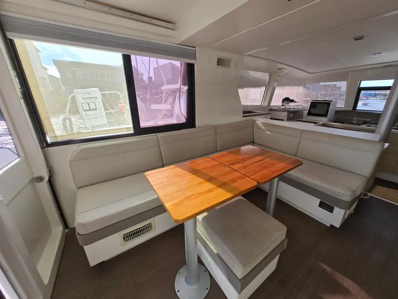 Slide: The Image of Interior of 2018 Bali 4.1 Catamaran with cozy seating and wooden table. - 40