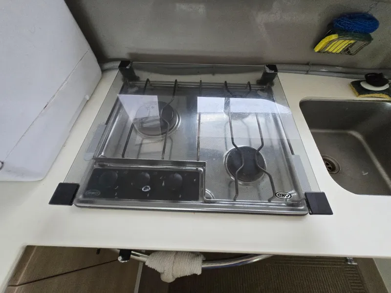 Slide: The Image of Compact kitchen stove on 2018 Bali 4.1 Catamaran with two burners and glass cover. - 41