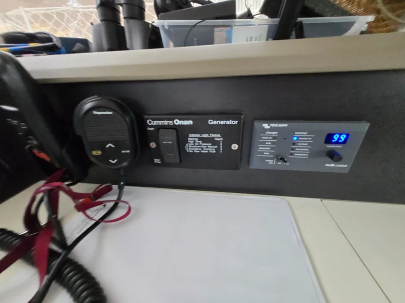 Slide: The Image of Control panel on a 2018 Bali 4.1 Catamaran featuring Cummins Onan generator. - 71