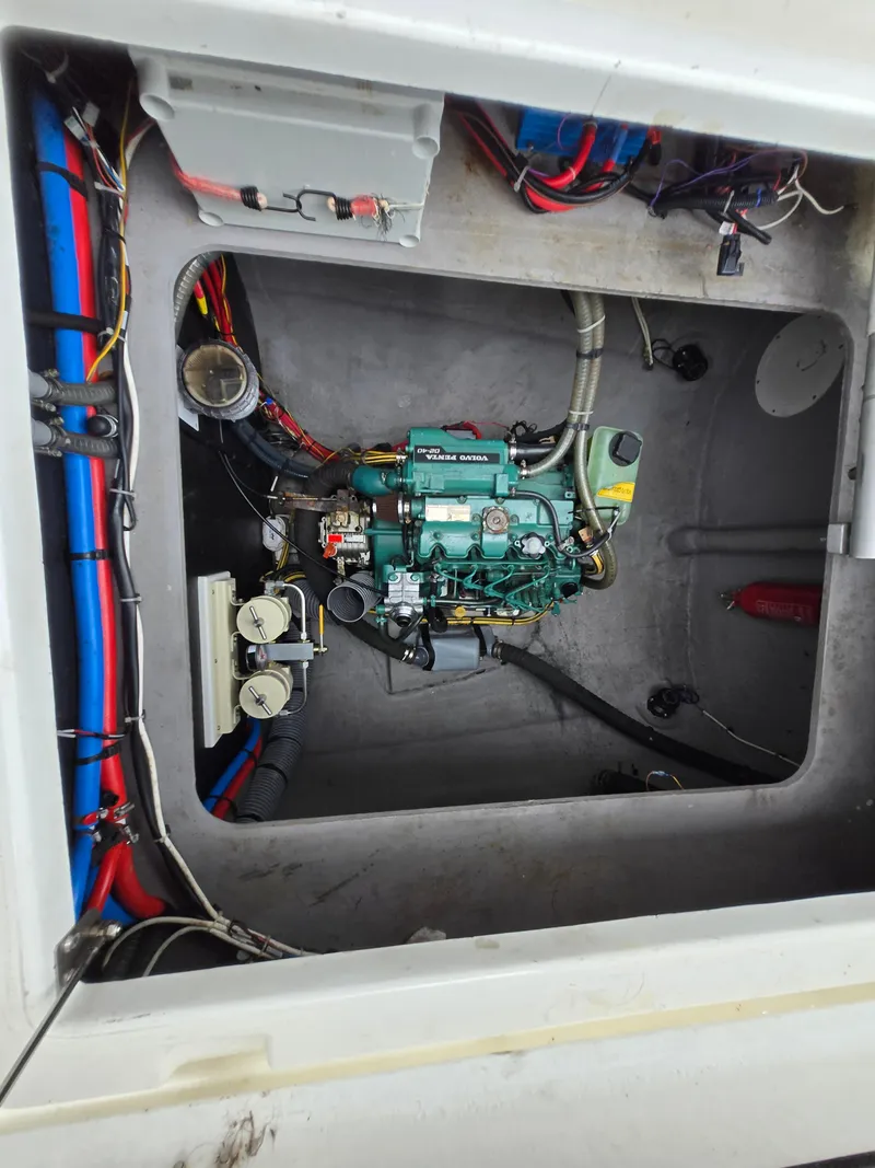 Slide: The Image of Engine compartment of a 2018 Bali 4.1 Catamaran with visible wiring and components. - 77