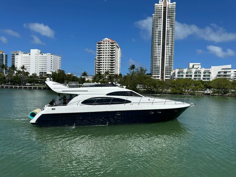 The Image of Luxury 1997 Azimut 54 yacht cruising in a scenic urban waterfront setting. - 0