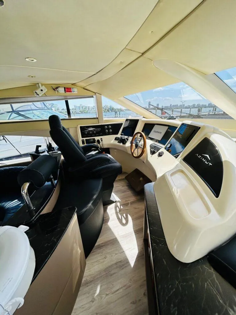 Slide: The Image of Interior view of a 1997 Azimut 54 yacht cockpit with modern controls and steering wheel. - 11
