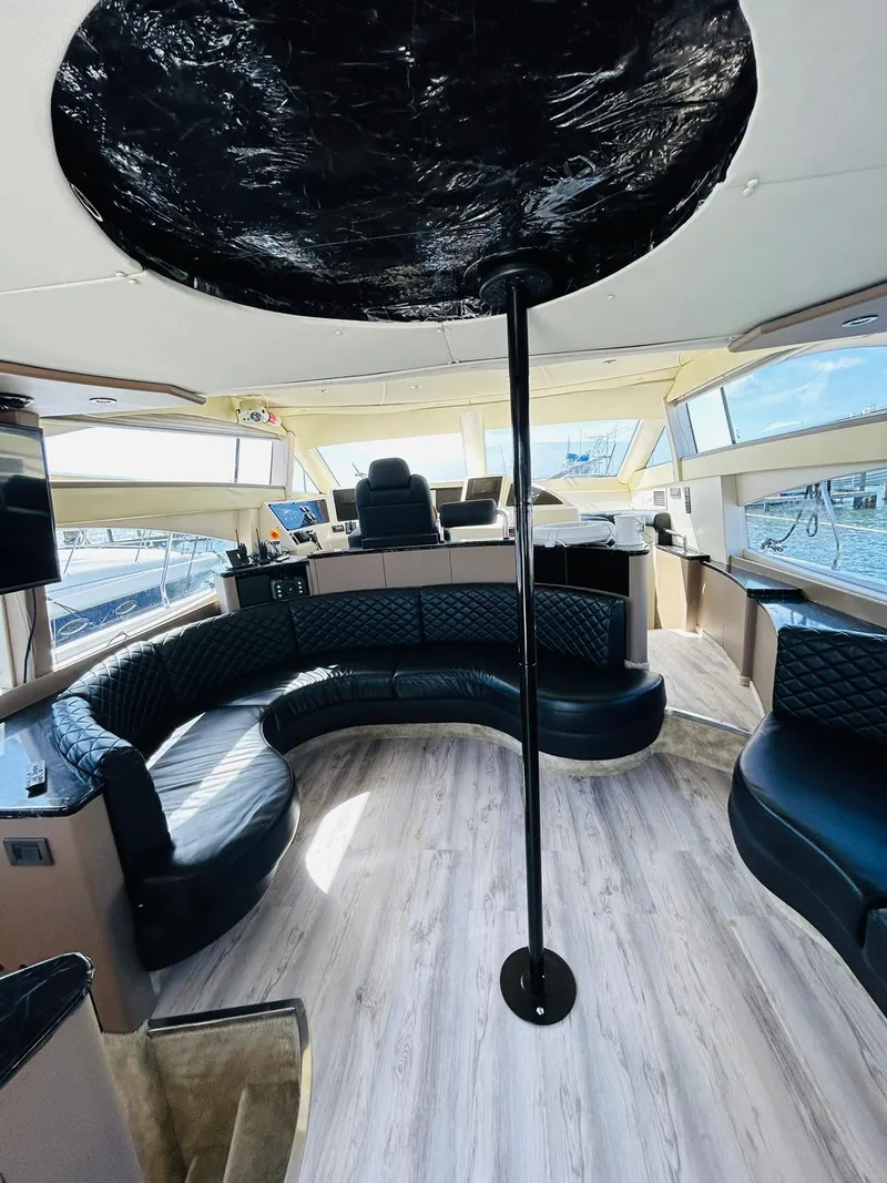 Slide: The Image of Luxurious interior of a 1997 Azimut 54 yacht with modern seating and panoramic windows. - 13