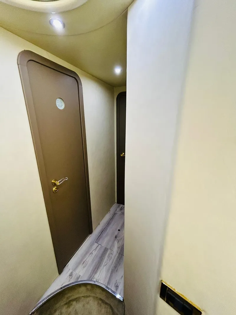 Slide: The Image of Interior hallway of a 1997 Azimut 54 yacht with wooden doors and modern lighting. - 18