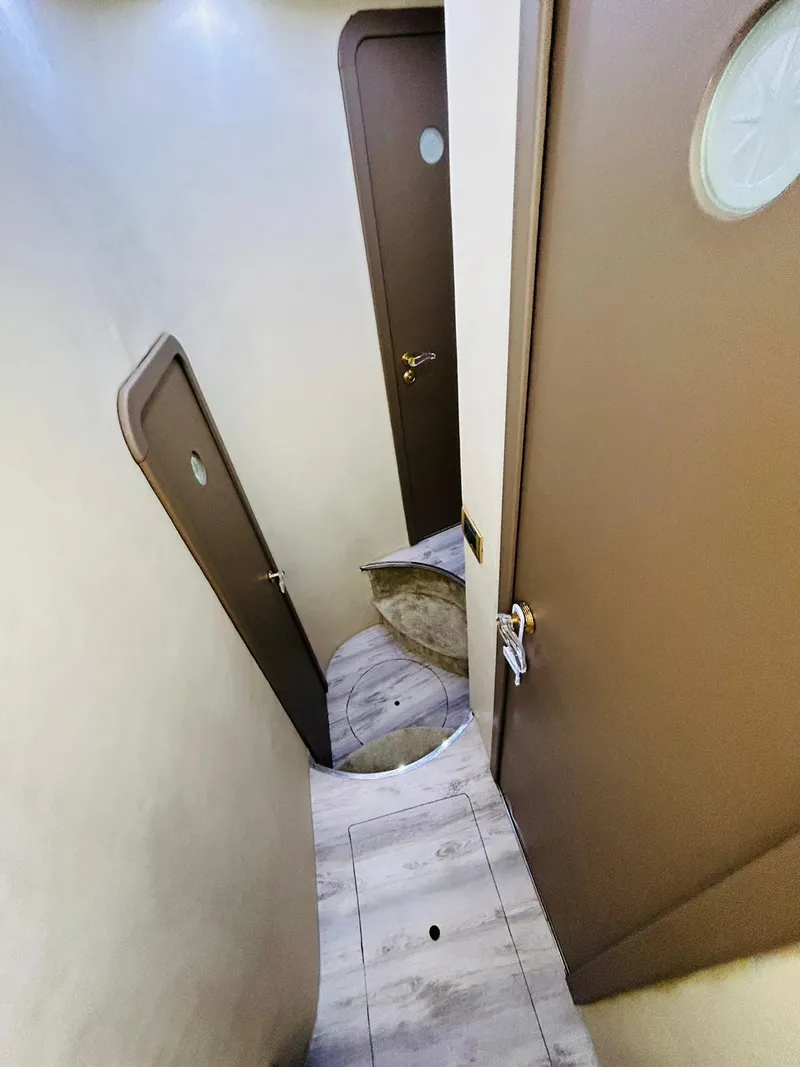 Slide: The Image of Narrow hallway with wooden doors and steps inside a 1997 Azimut 54 yacht. - 19