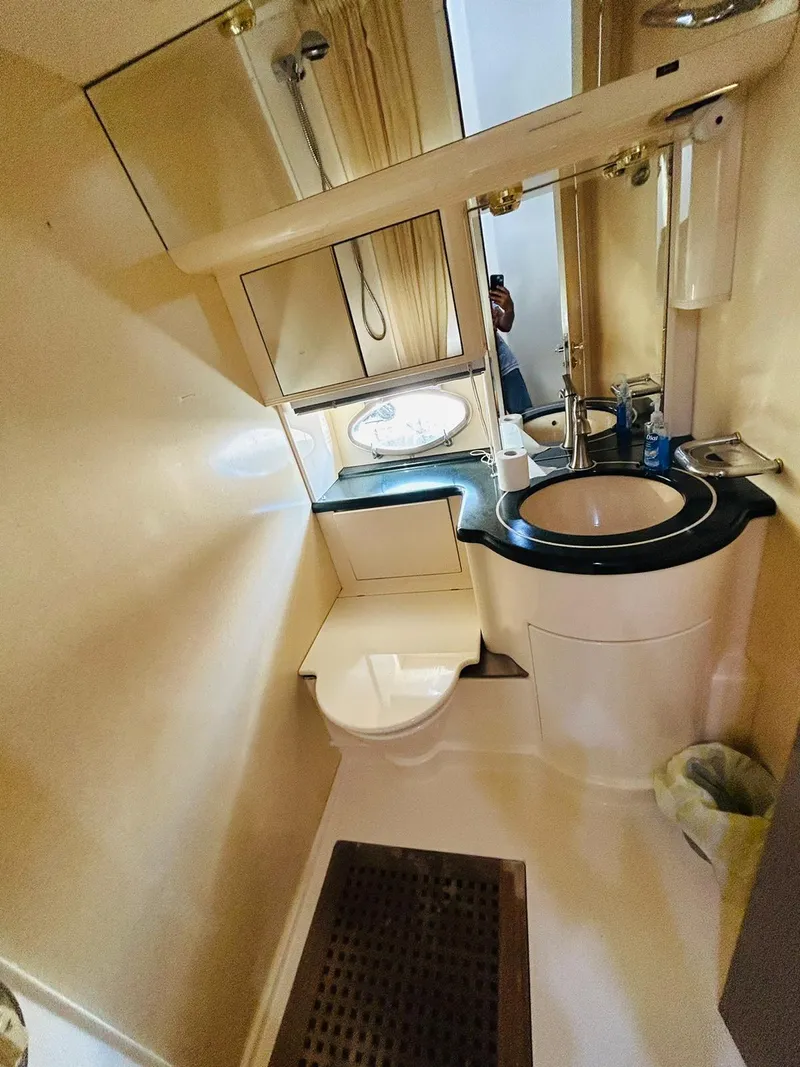 Slide: The Image of Bathroom interior of a 1997 Azimut 54 yacht, featuring a sink and toilet. - 20