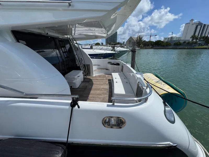 Slide: The Image of Luxury 1997 Azimut 54 yacht docked, featuring spacious deck and sleek design. - 23