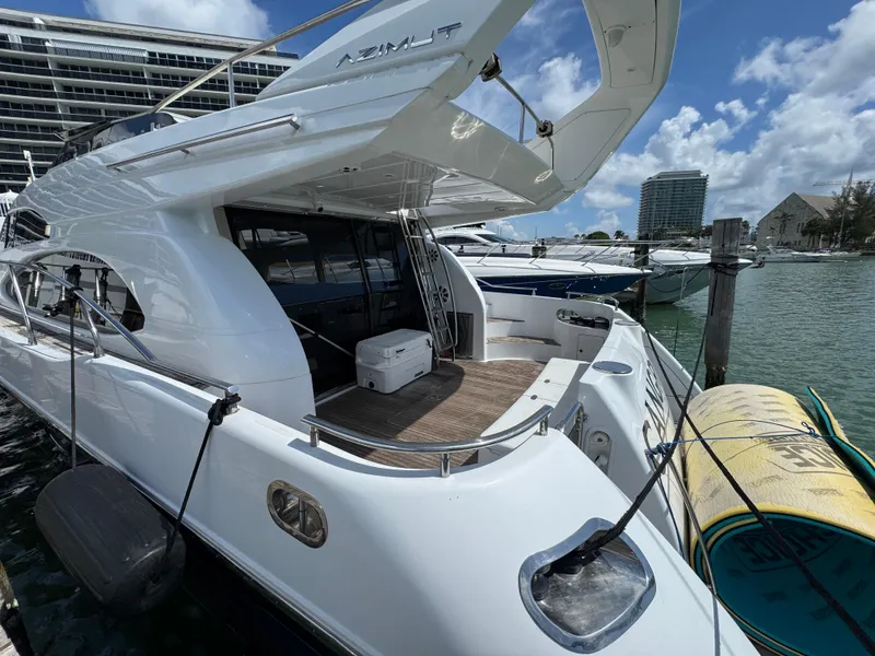 Slide: The Image of Luxury 1997 Azimut 54 yacht docked at marina under blue sky. - 24