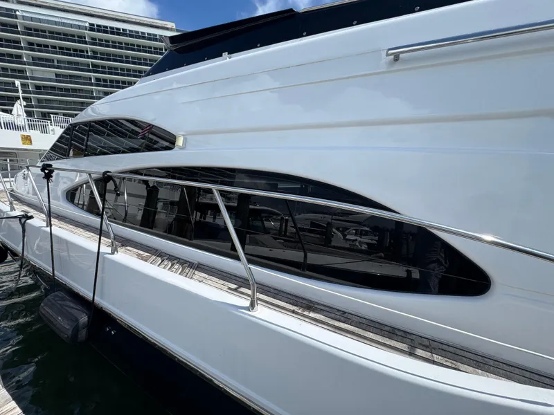 Slide: The Image of 1997 Azimut 54 yacht docked, showcasing sleek white exterior and modern design. - 25