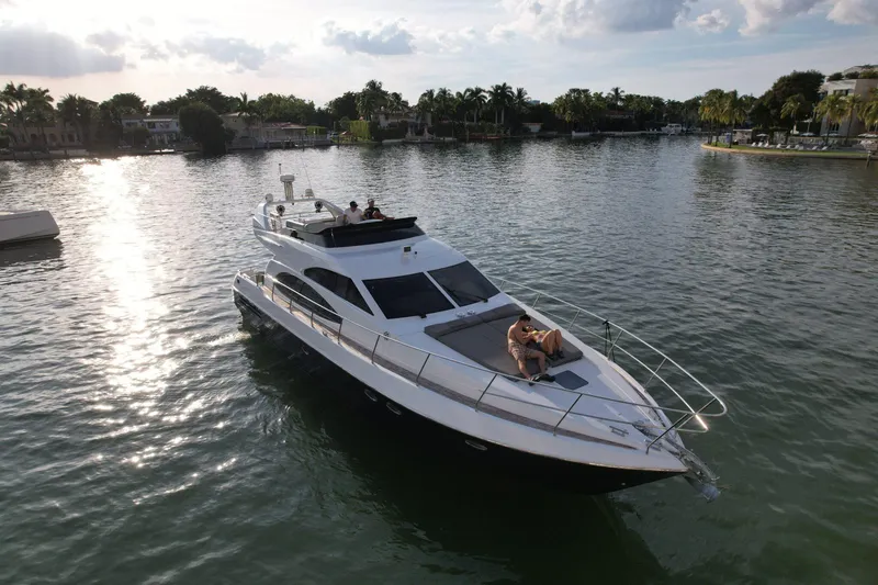 Slide: The Image of Azimut 54 yacht from 1997 cruising on a serene waterway at sunset. - 3