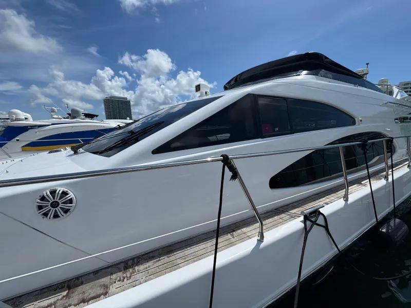 Slide: The Image of 1997 Azimut 54 yacht docked under a clear blue sky. - 30