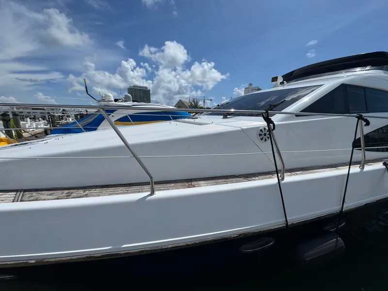 Slide: The Image of 1997 Azimut 54 yacht docked under a clear blue sky. - 31