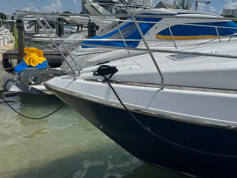 Slide: The Image of Azimut 54 yacht from 1997 docked at a marina, featuring sleek design and vibrant covers. - 33