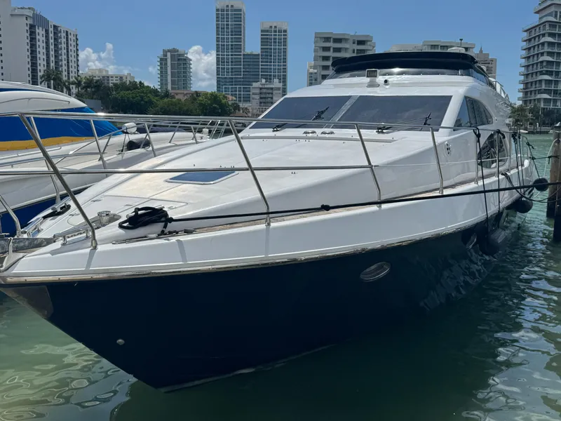 Slide: The Image of Luxury 1997 Azimut 54 yacht docked in marina, surrounded by modern buildings. - 34