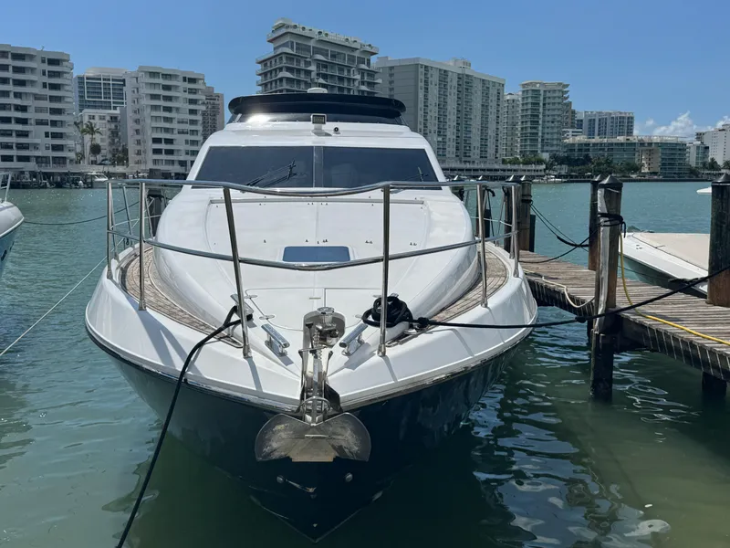 Slide: The Image of Front view of a 1997 Azimut 54 yacht docked in a marina. - 35