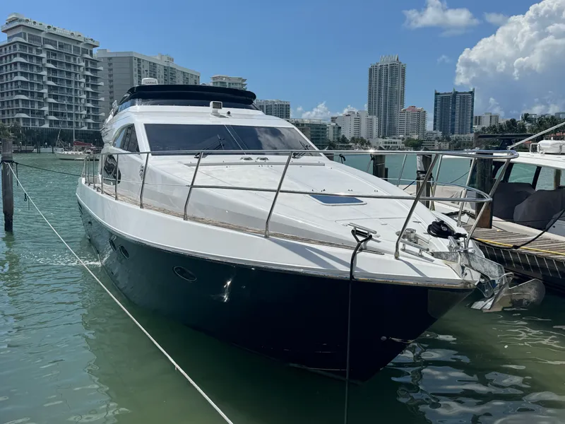 Slide: The Image of 1997 Azimut 54 yacht docked in a marina with city skyline background. - 36