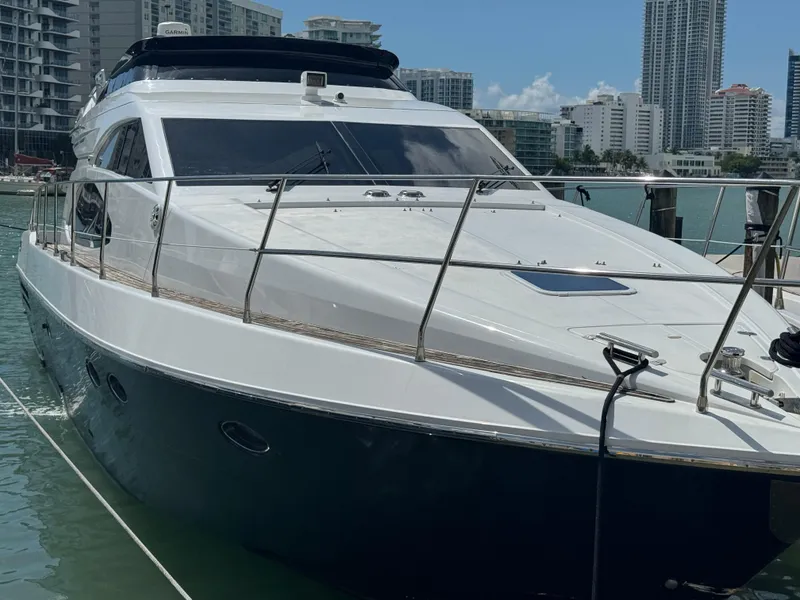 Slide: The Image of 1997 Azimut 54 yacht docked in a marina with city skyline background. - 37
