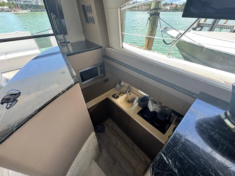 Slide: The Image of Interior of 1997 Azimut 54 yacht kitchen with modern appliances and waterfront view. - 44