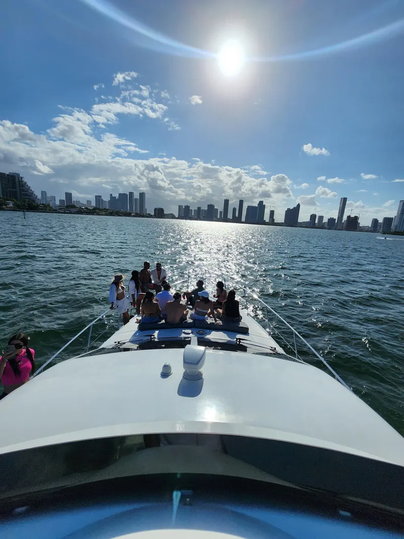 Slide: The Image of Group enjoying sunny day on 1997 Azimut 54 yacht, city skyline in background. - 6