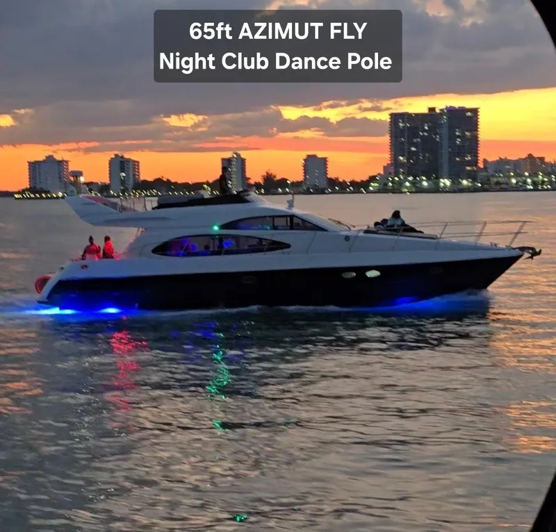 Slide: The Image of Luxury Azimut 54 yacht cruising at sunset with city skyline backdrop. - 7